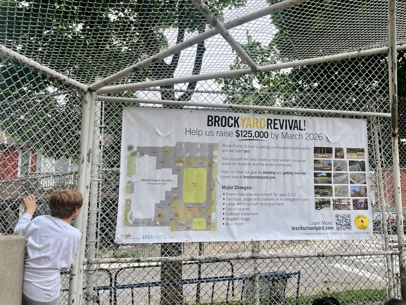 Vinyl banner depicited details of the site design, hanging in the baseball backstop